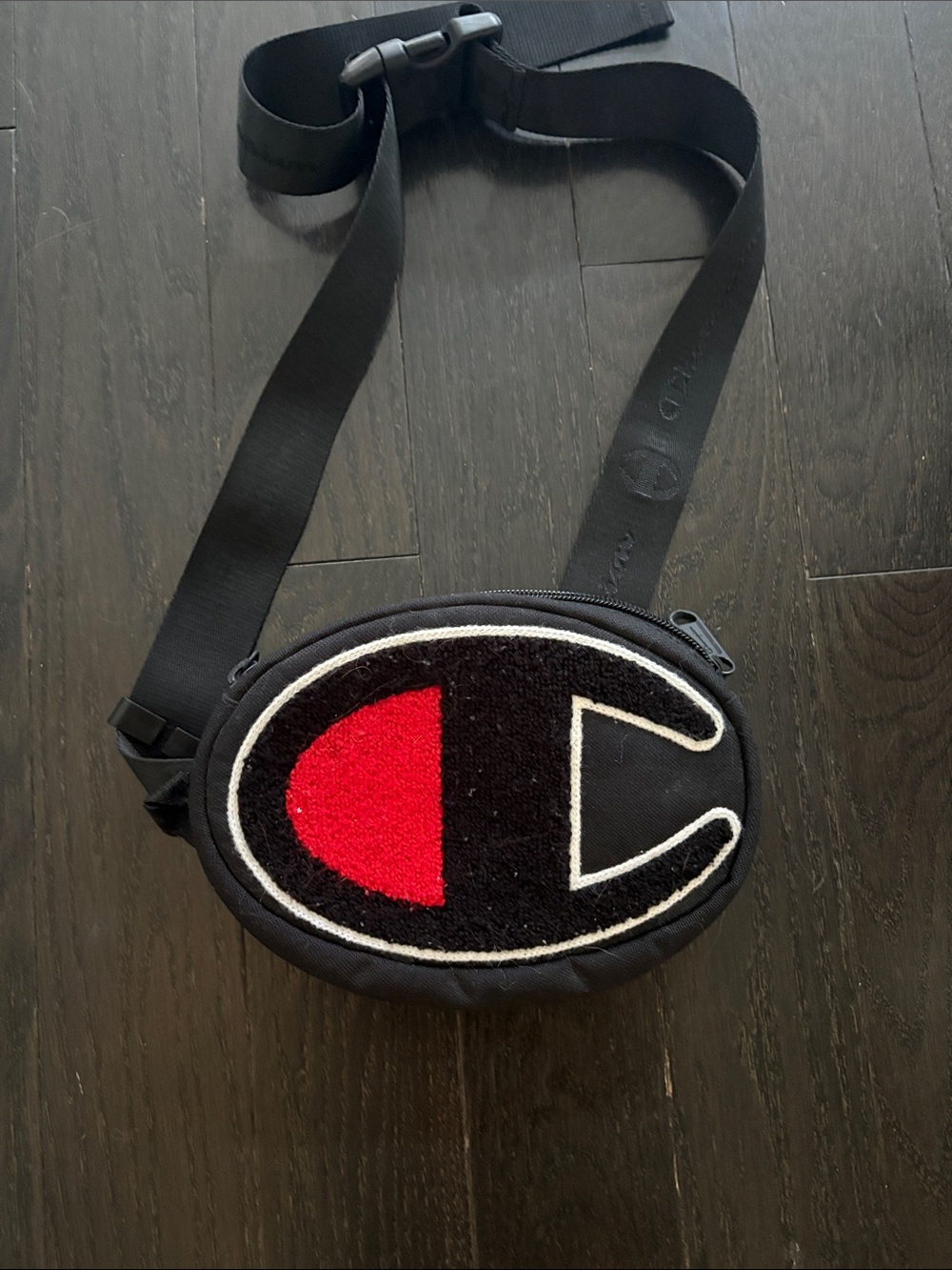 Champion Black Oval Crossbody with Red Accent Logo